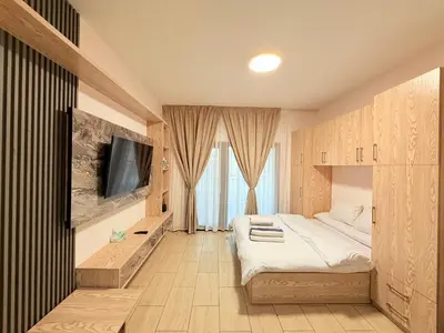a hotel room with a bed and a tv at Studio in Dow Heights Compound in Hurghada