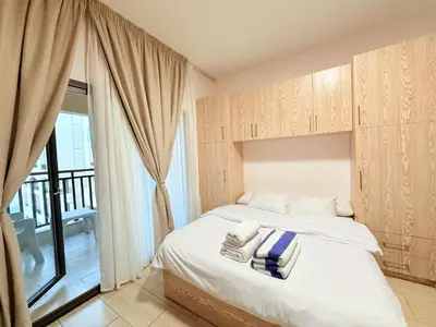 a bedroom with a bed and a large window at Studio in Dow Heights Compound in Hurghada