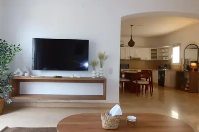 a living room with a large flat screen tv on a wall at Spacious 1bd on the Beach - White Villas, El Gouna in Hurghada