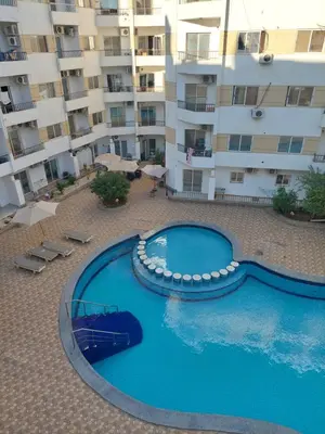 a large swimming pool in front of a building at Hurghada in Hurghada