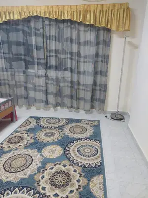 a rug on the floor in front of a curtain at Hurghada in Hurghada
