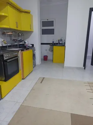 a kitchen with yellow cabinets and a stove at Hurghada in Hurghada