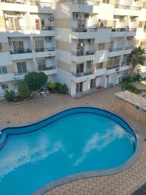an empty swimming pool in front of a building at Hurghada in Hurghada