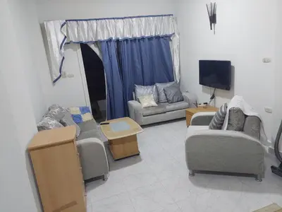 a living room with two couches and a tv at Hurghada in Hurghada