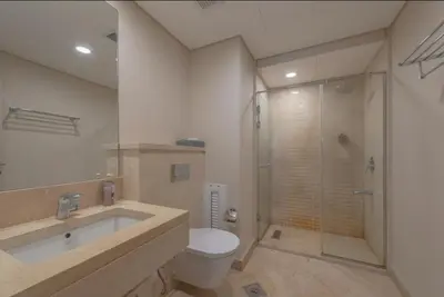 a bathroom with a toilet and a sink and a shower at Mangroovy- 1br GF Waterfront Glitzy direct pool in Hurghada