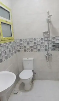 a bathroom with a toilet and a sink at براديس الاحياء in Hurghada