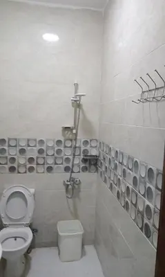 a white bathroom with a toilet and a shower at براديس الاحياء in Hurghada