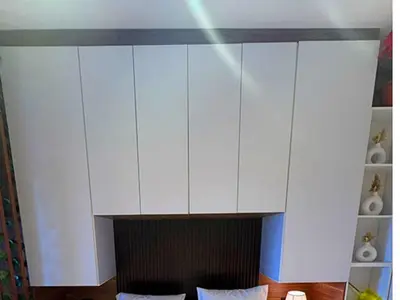 a white cabinet above a fireplace with two pillows at More Relaxation Aldau Heights Studio in Hurghada in Hurghada
