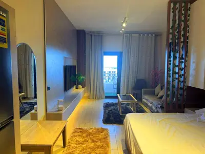 a bedroom with a bed and a living room at More Relaxation Aldau Heights Studio in Hurghada in Hurghada