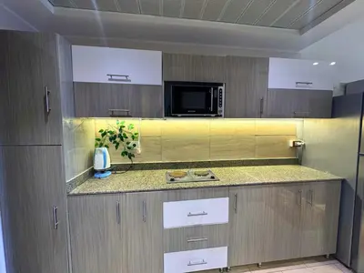 a kitchen with a counter top and a microwave at More Relaxation Aldau Heights Studio in Hurghada in Hurghada