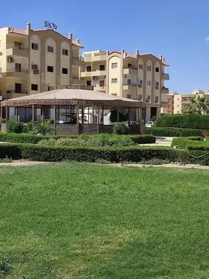 a large building with a green lawn in front of it at كمبوند سكاي 2 in Hurghada