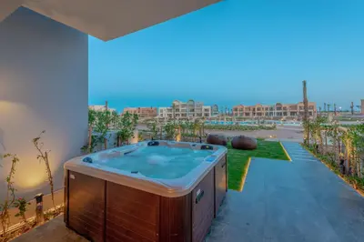 a hot tub on a patio with a view at Chic 1 BR with private jacuzzi in Banī Ghālib