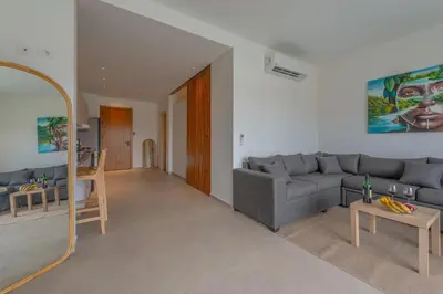 a living room with a couch and a table at Chic 1 BR with private jacuzzi in Banī Ghālib