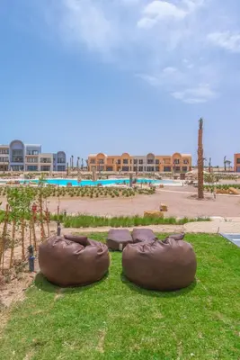 two large brown objects on the grass in front of a building at Chic 1 BR with private jacuzzi in Banī Ghālib