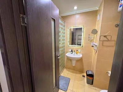 a bathroom with a sink and a toilet and a mirror at Coral Aldau Heights one bedroom apartment in hurghada in Hurghada