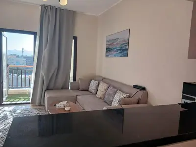 a living room with a couch and a large window at Crystal Aldau Heights one bedroom apartment in Hurghada in Hurghada