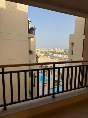 a balcony with a view of a pool at Crystal Aldau Heights one bedroom apartment in Hurghada in Hurghada