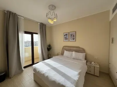 a bedroom with a large bed and a window at Paradise Aldau Heights one bedroom apartment in Hurghada in Hurghada