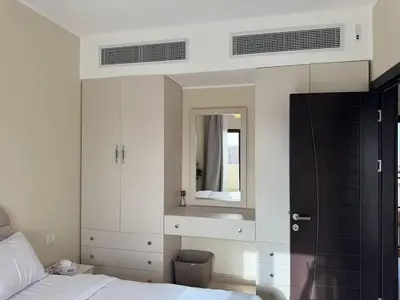 a bedroom with a bed and a mirror at Paradise Aldau Heights one bedroom apartment in Hurghada in Hurghada