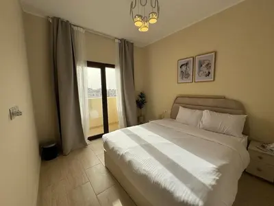 a bedroom with a large white bed and a window at Paradise Aldau Heights one bedroom apartment in Hurghada in Hurghada