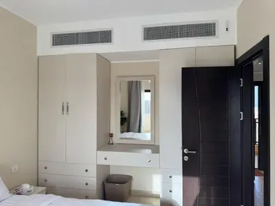 a bedroom with a bed and a mirror at Paradise Aldau Heights one bedroom apartment in Hurghada in Hurghada