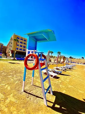 a lifeguard station on a beach with chairs and a life preserver at B1-04 Juliana in Hurghada