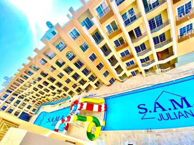 a large hotel with a swimming pool in front of it at B1-04 Juliana in Hurghada