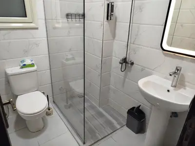 a bathroom with a shower and a toilet and a sink at B1-04 Juliana in Hurghada