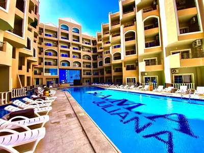 a hotel swimming pool with lounge chairs and a resort at B1-04 Juliana in Hurghada