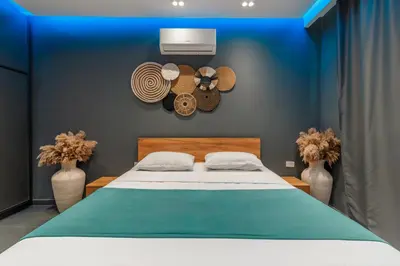 a bedroom with a bed with hats on the wall at Al Saraya Sahl Hasheesh by Peaks One Bedroom Apartment with Pool View C201 in Hurghada