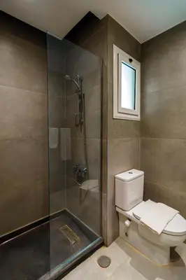 a bathroom with a toilet and a glass shower at Al Saraya Sahl Hasheesh by Peaks One Bedroom Apartment with Pool View C201 in Hurghada