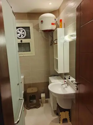 a small bathroom with a sink and a toilet at Princess Resort apartment Hurghada in Hurghada