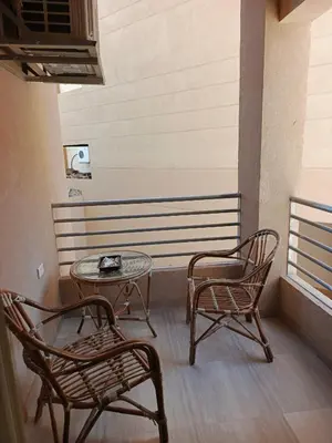 two chairs and a table and a bench on a balcony at Princess Resort apartment Hurghada in Hurghada