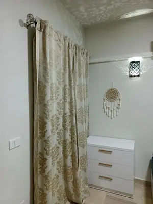 a bathroom with a shower curtain and a dresser at Princess Resort apartment Hurghada in Hurghada