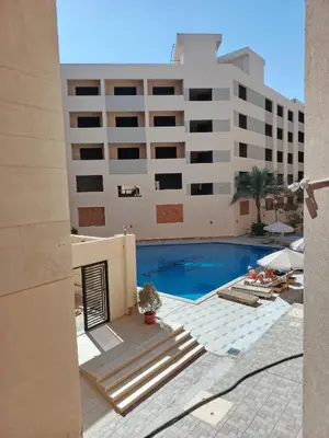 a view of a building and a swimming pool at Princess Resort apartment Hurghada in Hurghada