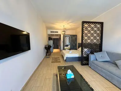 a living room with a couch and a bed at Aldau Heights studio in Hurghada gol in Hurghada
