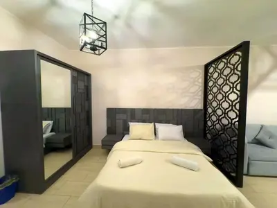 a bedroom with a large bed and a mirror at Aldau Heights studio in Hurghada gol in Hurghada
