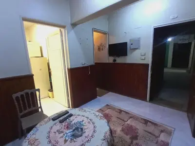 a room with a bed and a tv in a room at Aswan cozy apartment in Aswan