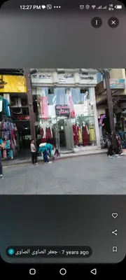 two people standing in front of a store at Aswan cozy apartment in Aswan