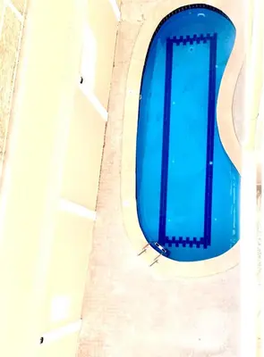 an overhead view of a swimming pool in a building at The Modern Nest Magawish in Hurghada
