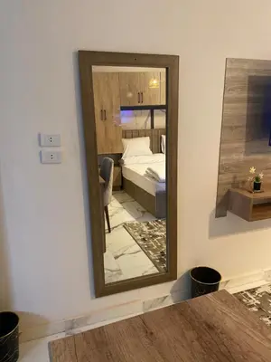 a mirror in a room with a bedroom at The Modern Nest Magawish in Hurghada