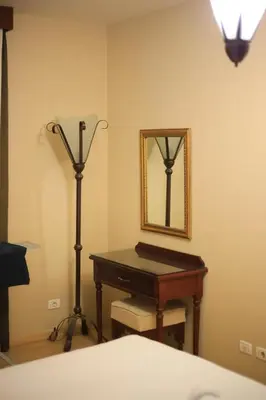 a bedroom with a desk and a mirror and a lamp at Port ghalib in Abu Dabab