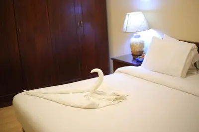 a swan towel on a bed in a hotel room at Port ghalib in Abu Dabab