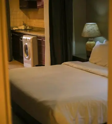 a bedroom with a bed and a washing machine at Port ghalib in Abu Dabab