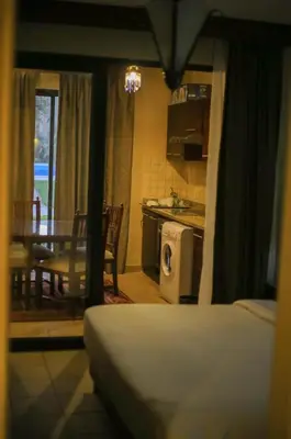 a kitchen and dining room with a table and a stove at Port ghalib in Abu Dabab