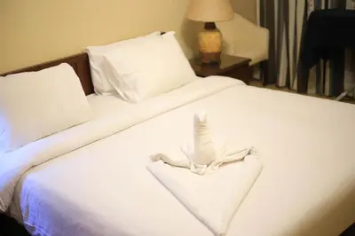 a white bed with a white towel on it at Port ghalib in Abu Dabab