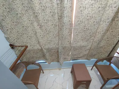 a room with two chairs and a table and curtains at شقه للايجار اليومى او الشهرىApartment for daily or monthly rent in Hurghada