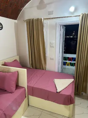 a bedroom with two beds and a window at Anno ka in Jazīrat Aswān