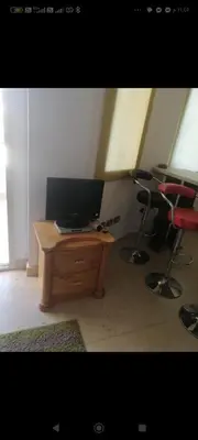 a room with a desk with a monitor and two chairs at Luxor Egypt in Al Baghdādī