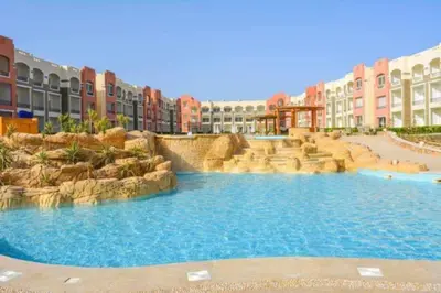 a large swimming pool in a resort with buildings at Oysterbay in Marsa Alam